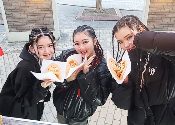 たこせんをもちながらピースをしている写真